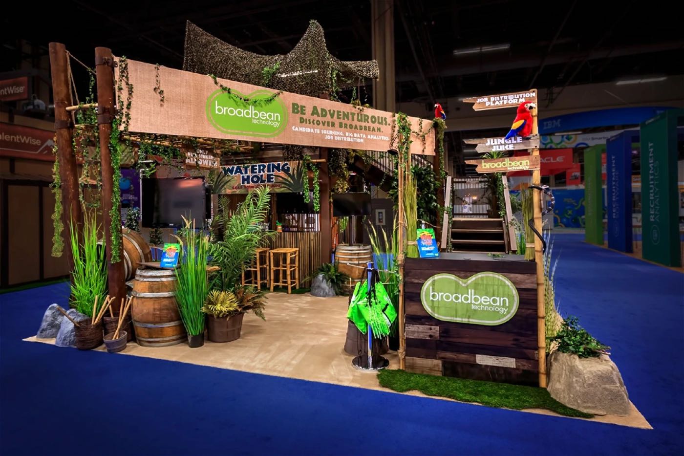 Broadbean booth themed as a jungle with plants and wood