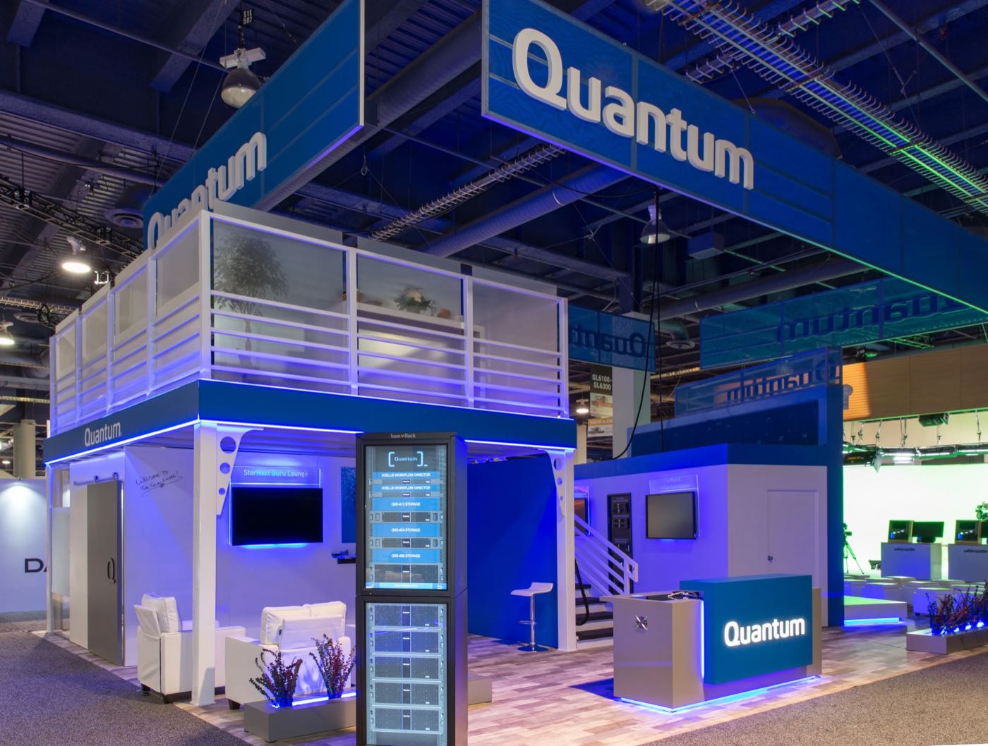Two-story Quantum booth with a blue overhead sign
